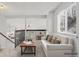 Bright, open-concept living room area with neutral decor and a view of the kitchen at 10731 W 63Rd Ave # A, Arvada, CO 80004