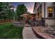 Stone patio with pathway, fire pit, and seating area at 5458 W Calhoun Ave, Littleton, CO 80123