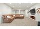 Finished basement with sectional sofa and large TV at 5458 W Calhoun Ave, Littleton, CO 80123