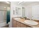 Bright bathroom with double sinks, shower, and toilet at 5458 W Calhoun Ave, Littleton, CO 80123