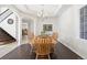 Bright dining room with hardwood floors and a wooden table with chairs at 5458 W Calhoun Ave, Littleton, CO 80123