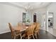 Formal dining room with hardwood floors, chandelier, and views into the kitchen and entry at 5458 W Calhoun Ave, Littleton, CO 80123