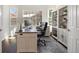 Home office with built-in shelving, desk, and large windows at 5458 W Calhoun Ave, Littleton, CO 80123