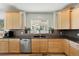 Kitchen with granite countertops and light wood cabinets at 5458 W Calhoun Ave, Littleton, CO 80123