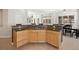 Kitchen island with cooktop, granite countertops, and light wood cabinets at 5458 W Calhoun Ave, Littleton, CO 80123