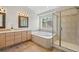 Main bathroom featuring a large shower and soaking tub at 5458 W Calhoun Ave, Littleton, CO 80123