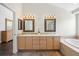 Main bathroom with double vanity, soaking tub, and shower at 5458 W Calhoun Ave, Littleton, CO 80123