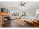 Main bedroom with fireplace, vaulted ceiling, and hardwood floors at 5458 W Calhoun Ave, Littleton, CO 80123