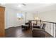 Upstairs sitting area with two leather chairs and ottoman at 5458 W Calhoun Ave, Littleton, CO 80123