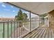 View from the balcony showcasing the community tennis court and well-maintained landscaping at 910 S Walden St # 201, Aurora, CO 80017