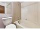 Clean bathroom featuring a tub and shower combo with tiled walls, a toilet, and white vanity at 910 S Walden St # 201, Aurora, CO 80017