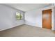 Comfortable bedroom with neutral carpeting, ample natural light and a view of the outdoors at 910 S Walden St # 201, Aurora, CO 80017