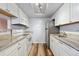 Updated kitchen featuring stone countertops, white cabinets and modern appliances including a stainless steel refrigerator and dishwasher at 910 S Walden St # 201, Aurora, CO 80017
