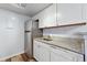 This modern kitchen features stainless steel appliances, granite counters, and white cabinets for a clean look at 910 S Walden St # 201, Aurora, CO 80017