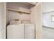 Convenient laundry closet with modern washer and dryer units for easy chore days at 910 S Walden St # 201, Aurora, CO 80017
