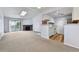 Inviting living space with stone fireplace, balcony access, and updated kitchen featuring white cabinets and modern appliances at 910 S Walden St # 201, Aurora, CO 80017