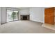 Spacious living room with a stone fireplace and sliding glass doors to a balcony, flooding the room with natural light at 910 S Walden St # 201, Aurora, CO 80017