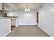 Cozy living room featuring neutral carpeting, white walls and white trimmed kitchen in an open space at 910 S Walden St # 201, Aurora, CO 80017