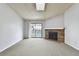 Bright living room featuring sliding doors to the balcony and a stone fireplace; skylight provides natural light at 910 S Walden St # 201, Aurora, CO 80017