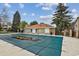 Community pool with a safety cover, surrounded by a fence and residential buildings at 910 S Walden St # 201, Aurora, CO 80017