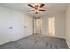 Cozy bedroom features gray carpet, a ceiling fan, and closet storage at 4400 S Quebec St # D203, Denver, CO 80237