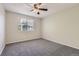 Bedroom features neutral colored walls and carpet with a window view at 4400 S Quebec St # D203, Denver, CO 80237