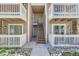 Condo exterior featuring stairs leading to multiple units, white railings, and rock landscaping at 4400 S Quebec St # D203, Denver, CO 80237