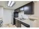The functional kitchen includes stainless appliances, stone countertops, and ample storage space at 4400 S Quebec St # D203, Denver, CO 80237