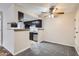 Cozy eat-in kitchen with dark cabinetry, modern appliances, and an open view to the living area at 4400 S Quebec St # D203, Denver, CO 80237