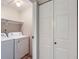 Laundry room with full size washer and dryer hookups and shelving at 4400 S Quebec St # D203, Denver, CO 80237