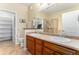 Bathroom with double vanity, walk-in closet, and tiled walk-in shower at 11962 W Long Cir # 103, Littleton, CO 80127