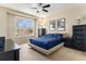 Comfortable bedroom with a large window and ample storage space, with neutral carpet at 11962 W Long Cir # 103, Littleton, CO 80127
