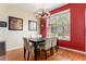 Cozy dining room with modern chandelier and a large window offering natural light at 11962 W Long Cir # 103, Littleton, CO 80127