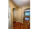Inviting foyer featuring gleaming hardwood floors and arched doorways leading to other rooms at 11962 W Long Cir # 103, Littleton, CO 80127