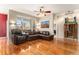 Bright living room with hardwood floors, large windows, and comfortable leather furniture at 11962 W Long Cir # 103, Littleton, CO 80127