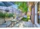 Charming backyard patio featuring a small table, seating, and view of the backyard and landscaping at 3530 E 8Th Ave, Denver, CO 80206