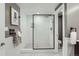Bathroom featuring a glass-enclosed shower, towel rack, and modern fixtures at 3530 E 8Th Ave, Denver, CO 80206
