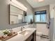 Modern bathroom featuring a stylish vanity, large mirror, and a combination of tile and neutral wall-tones at 3530 E 8Th Ave, Denver, CO 80206
