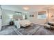Comfortable bedroom with a large bed, stylish rug, and two windows for plenty of natural light at 3530 E 8Th Ave, Denver, CO 80206