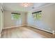 Well-lit bedroom with hardwood floors and two large windows providing ample natural light at 3530 E 8Th Ave, Denver, CO 80206