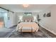 Stylish bedroom with a tufted headboard, sliding barn door, bench, and modern decor at 3530 E 8Th Ave, Denver, CO 80206