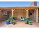 Inviting covered patio area, complete with a seating arrangement, plants, and stone flooring at 3530 E 8Th Ave, Denver, CO 80206
