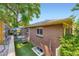 Exterior view showing brick facade, yard, patio, and landscaping at 3530 E 8Th Ave, Denver, CO 80206