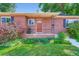 Charming brick home featuring a well-manicured lawn and a quaint front porch at 3530 E 8Th Ave, Denver, CO 80206