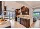 Modern kitchen boasts rich wood cabinetry, stainless steel appliances, quartz countertops, and backyard access at 3530 E 8Th Ave, Denver, CO 80206