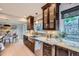 Stylish kitchen featuring custom wood cabinets, quartz countertops, a stainless steel sink, and a window view at 3530 E 8Th Ave, Denver, CO 80206