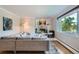 Cozy living room with a fireplace, comfortable seating, and a large window offering natural light at 3530 E 8Th Ave, Denver, CO 80206