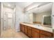 Bathroom with double sinks, a large mirror, and tile flooring at 11368 Navajo Cir # B, Denver, CO 80234