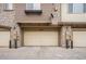 Exterior view of garages with stone and siding accents at 11368 Navajo Cir # B, Denver, CO 80234