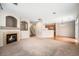 Open-concept living room with fireplace flowing into the dining and kitchen areas at 11368 Navajo Cir # B, Denver, CO 80234